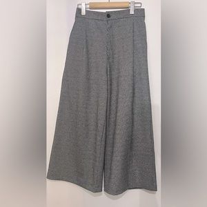 High waisted wide leg pants. Elastic back and zipper button closure.